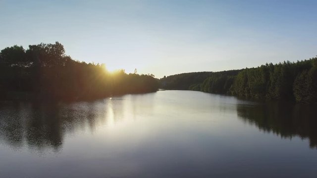 Sunset over the river in the countryside. Aerial view 4K