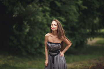 Close up Portrait, Young beautiful blonde woman in dress posing outdoors. Sunny weather