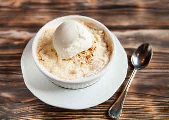 Tasty dessert with an ice cream ball on a wooden background