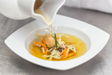 Chef pouring soup