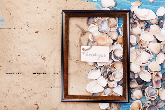 Sign Thank you with shells and photo frame. Vocation background