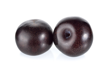 ripe black plum on white background