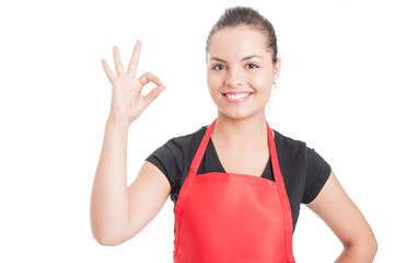 Cheerful female employee on supermarket doing ok sign - Powered by Adobe