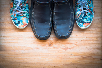 the leather and canvas shoe on wooden background. work life bala