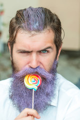 bearded man with blue beard and lollipop