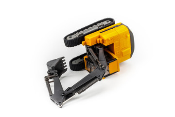 Overturned miniature excavator isolated on white background