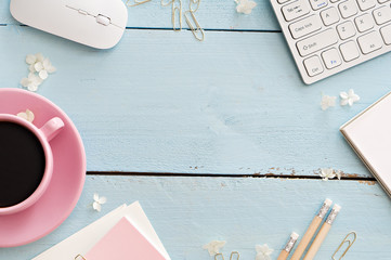 Office desk table with computer, supplies and coffee cup
