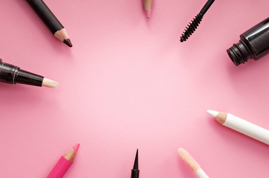set of cosmetic products on pink background