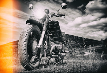 Freedom.Motorbike under sky.Vintage photo effect added for create atmosphere