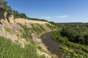 Fototapeta na wymiar Yellow Medicine River Scenic / A scenic river curving next to a cliff.