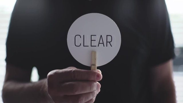 Man showing sign CLEAR