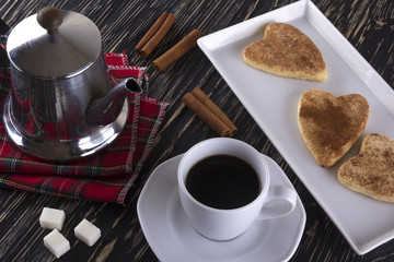 Cup of coffee with cinnamon cookies.