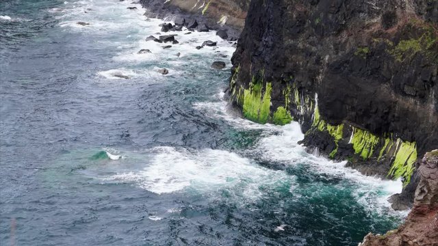 Waves breaking at the foot of a cliff at Idrigill Point, Macleod's Maidens on the Isle of Skye, Scotland, UK.