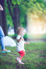 Naklejka premium Happy family of three lying in the grass .