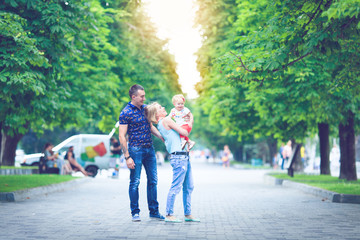 Happy family having weekend in summer park