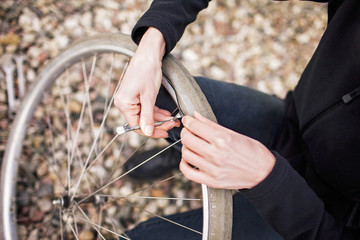 High angle view of female mechanic repairing bicycle tire
