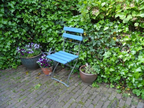 Let's Have Some Rest !! A Light Blue Chair In The Garden 