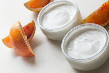 Yogurts or cosmetic cream assortment  in glass jar on ligth background. Natural, healthy, gourmet dessert for granola breakfast. Sweet yoghurts closeup with copy space.