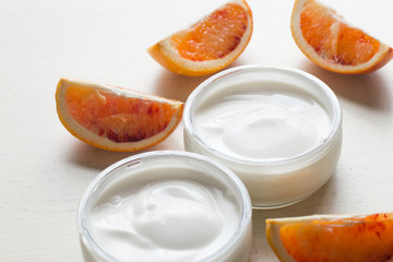 Yogurts or cosmetic cream assortment  in glass jar on ligth background. Natural, healthy, gourmet dessert for granola breakfast. Sweet yoghurts closeup with copy space.
