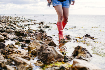 Low section of woman walking on beach
