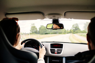 Cropped image of young woman driving car