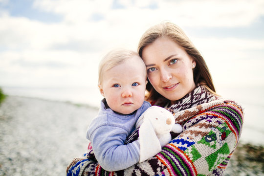 Portrait of woman with baby son outdoors