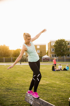 Midsection of sporty man holding basketball at court in park