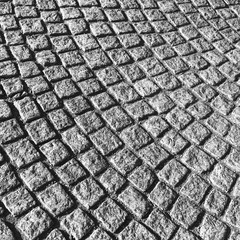 Naklejka premium Dark gray cobblestone street pavement