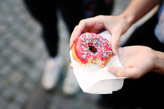 Cropped image of woman holding donut during festival
