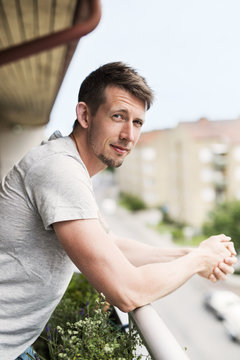 Portrait of man standing on balcony