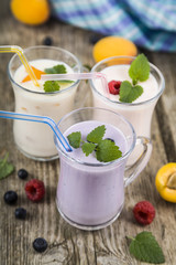 Smoothies with fresh berries on a wooden table
