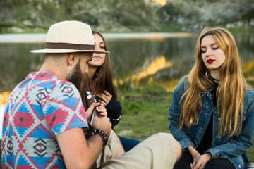 Fototapeta premium Friends playing music and singing in a lake