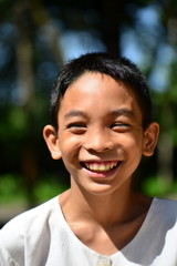 smile Asian boy in white shirt with nature
