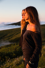 Blond and brunette girlfriends looking at the sunset