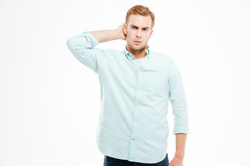Pensive young man thinking and scratching his head