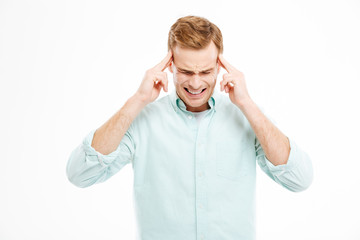 Stressful depressed man touching temples and having headache