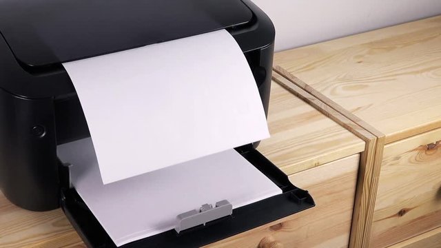 Office desktop laser printer printing single A4 letter page