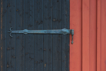 Ornamented hinge on a black barn door