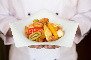 Cook holding plate with food