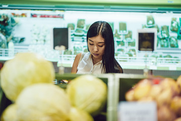 Beautiful azian girl shopping for groceries