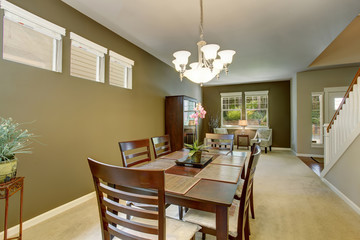 Dining area with deep brown table set and carpet floor