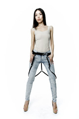 Young attractive woman wearing jeans with leather belt on white background