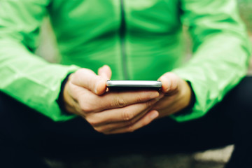 young sportsman using his smartphone
