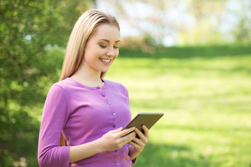 Fototapeta premium Beautiful young woman at garden