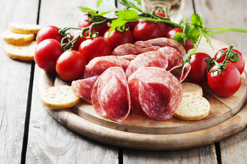 Fresh salami with tomato and bread