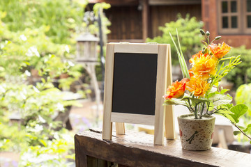 Empty menu advertising board and flower vase in home stay