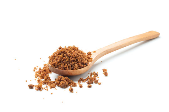 brown sugar with wooden spoon on white background