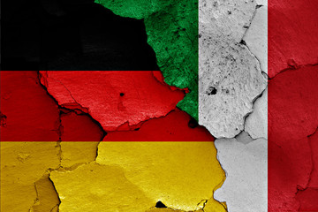 flags of Germany and Italy painted on cracked wall