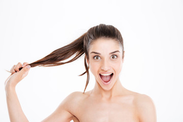 Naklejka premium Beauty portrait of happy excited young woman touching her hair