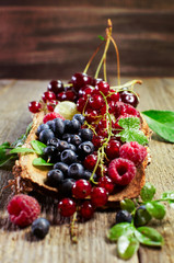 summer berries on a wooden surface.